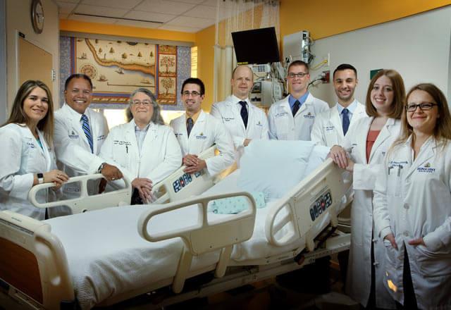 department posing by a hospital bed